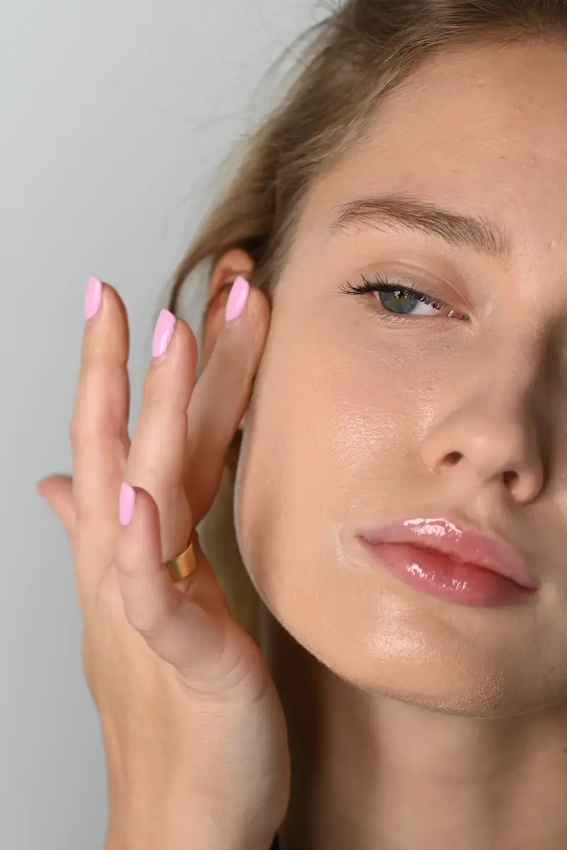 A woman blending foundation with her fingertips